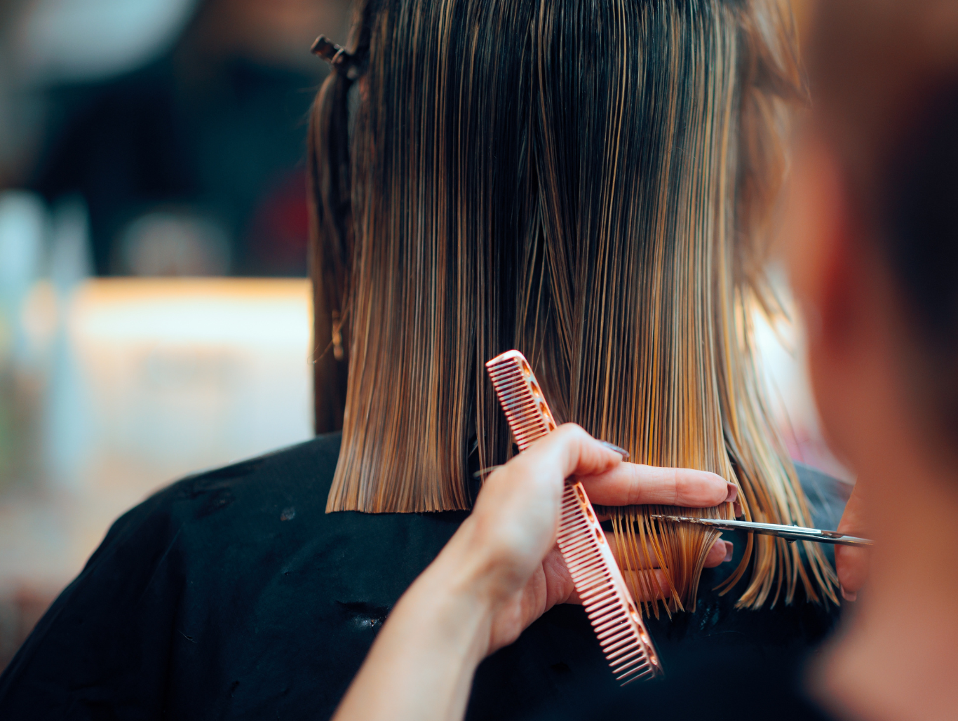 Close-up of professional hairdresser cutting a client’s hair at John Richards Hairdressing, Maidstone, showing precision and expert technique.