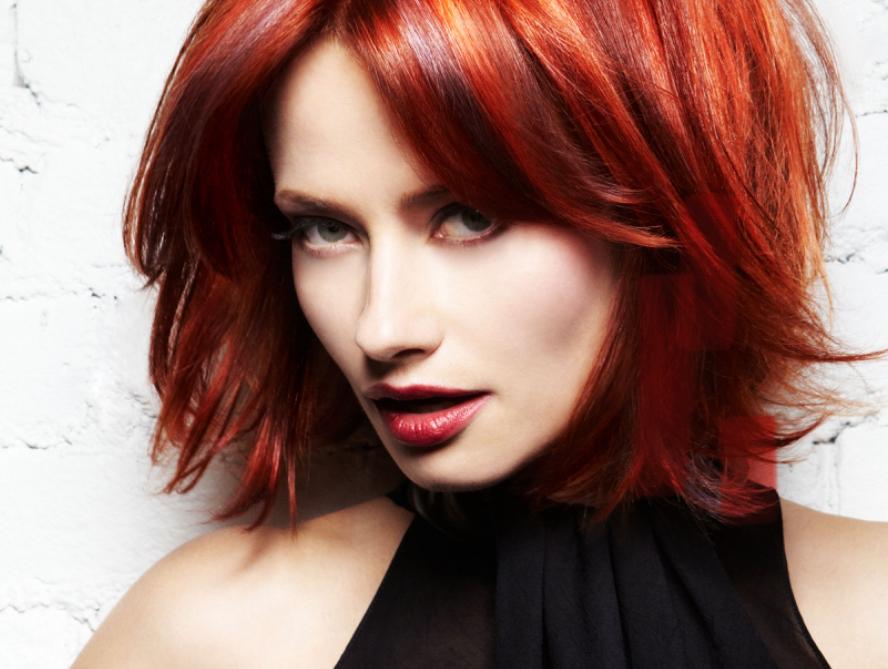 Confident mature woman with long, healthy silver-blonde hair, representing expert grey coverage and blending services at Jayne Elliott Hair Company in Lutterworth.