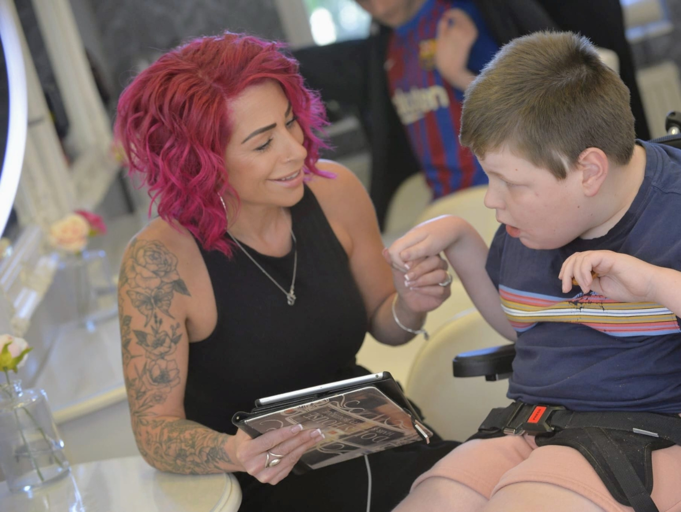 Belle at The Dolls House Boutique in Eastbourne creating a calm, supportive salon experience for a young autistic client, using personalised communication tools.